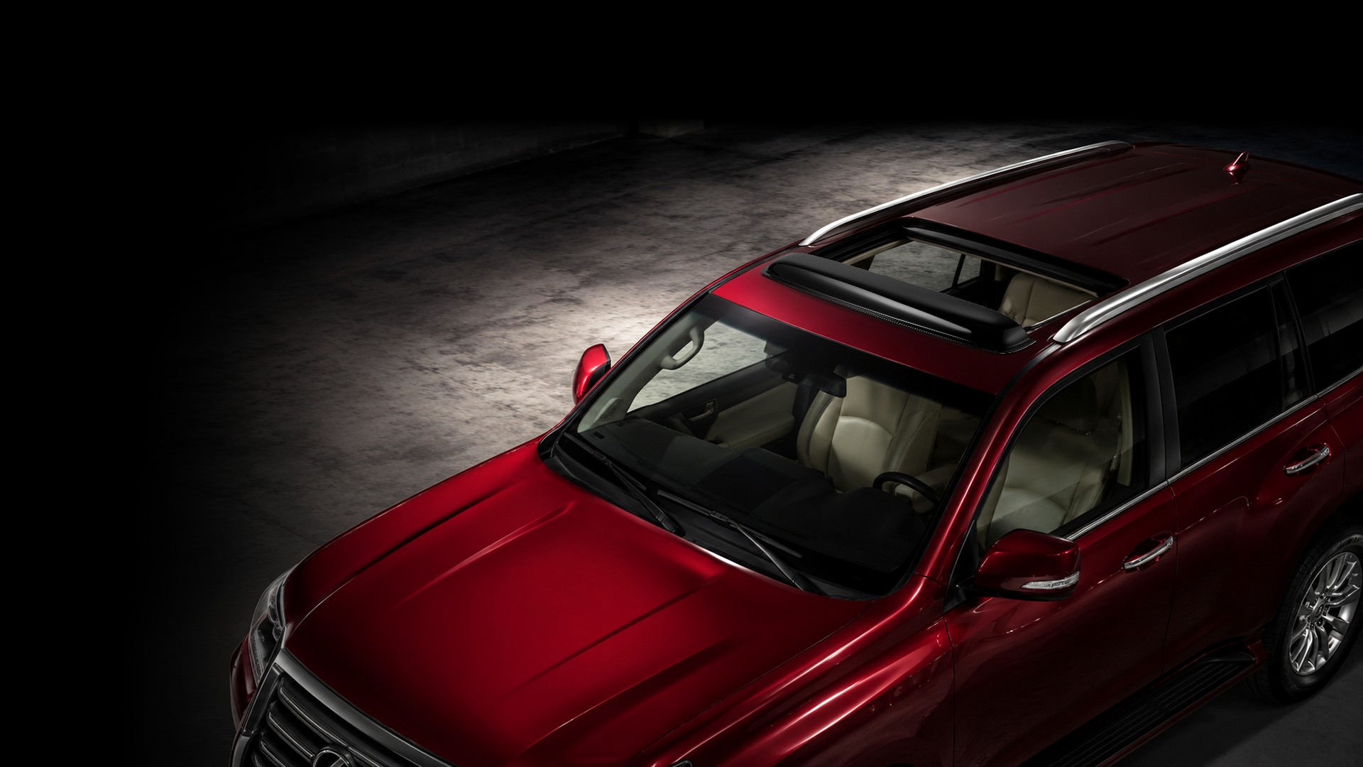 Voron Glass sunroof deflector mounted ahead of the roof opening on a red SUV