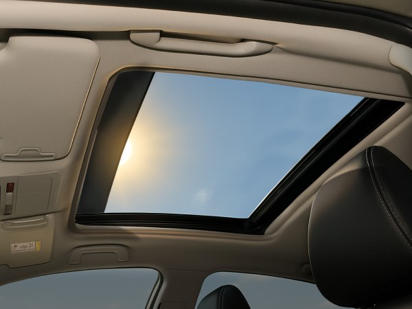 View of the sky through an open sunroof from inside the cabin