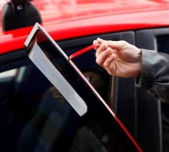 Positioning the Tape-On deflector against the window frame